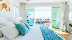 A bedroom with a large bed, a view of the balcony, and a pool area. - 4 Private EnSuites, 270* Lake View, pool+spa, Sleeps 12 (Indio)