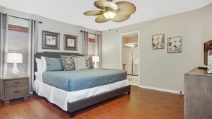 A bedroom with a bed, bedside tables, a ceiling fan, and framed artwork on the walls. - Tranquil Hideaway At Sandy Ridge 4 Bedroom Home (Davenport)