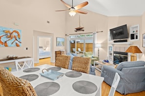 Cozy living room with a dining area, comfortable seating, and a fireplace.