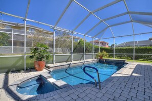 An indoor swimming pool with a clear glass roof, surrounded by a brick patio, and a large potted plant to the left. - 6 Bed, 2 Suites, Pool, Spa, Games Room #800 6 Bedroom Villa (Davenport)