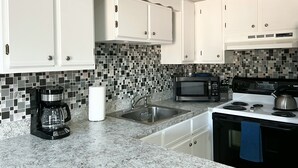 Coffee/tea maker, fridge, microwave, oven