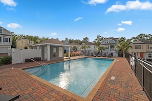 A swimming pool with a brick border, surrounded by houses. - The FUN Orange Home in a Great Location With Bonus Game Room (Panama City Beach)