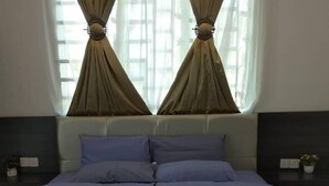 A bedroom with a bed, two bedside tables, and a window with curtains. - Captain's Cabin Resort  (Kota Bharu)