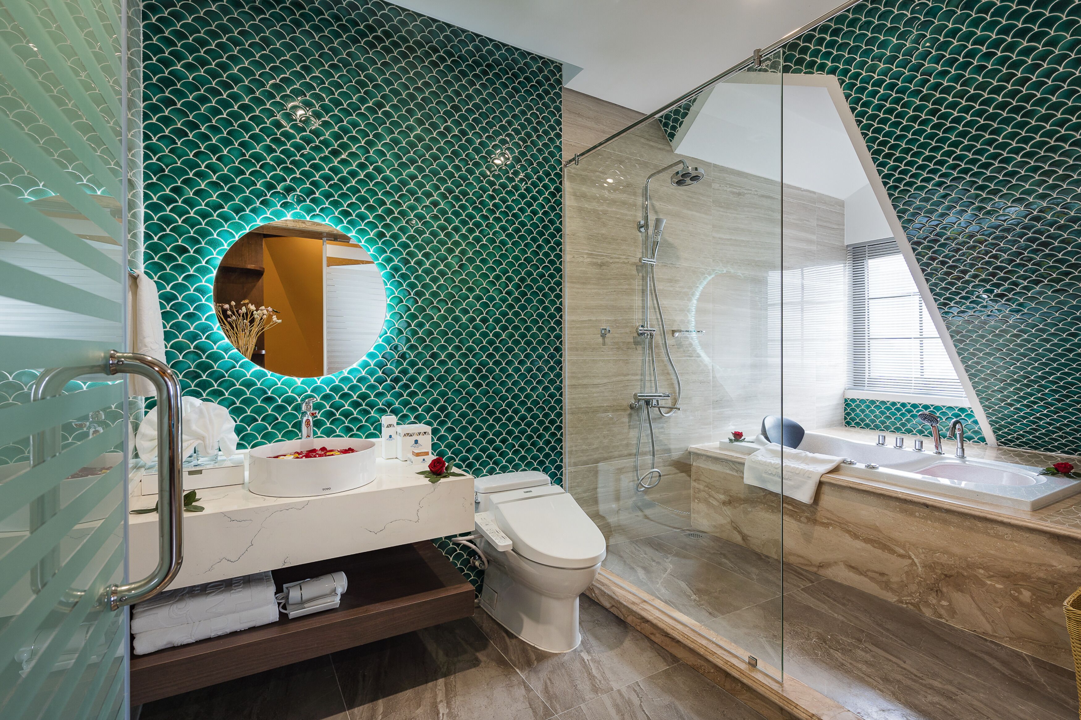 A modern bathroom with a glass-enclosed shower, a white sink, and a toilet.