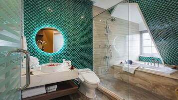 A modern bathroom with a glass-enclosed shower, a white sink, and a toilet.
