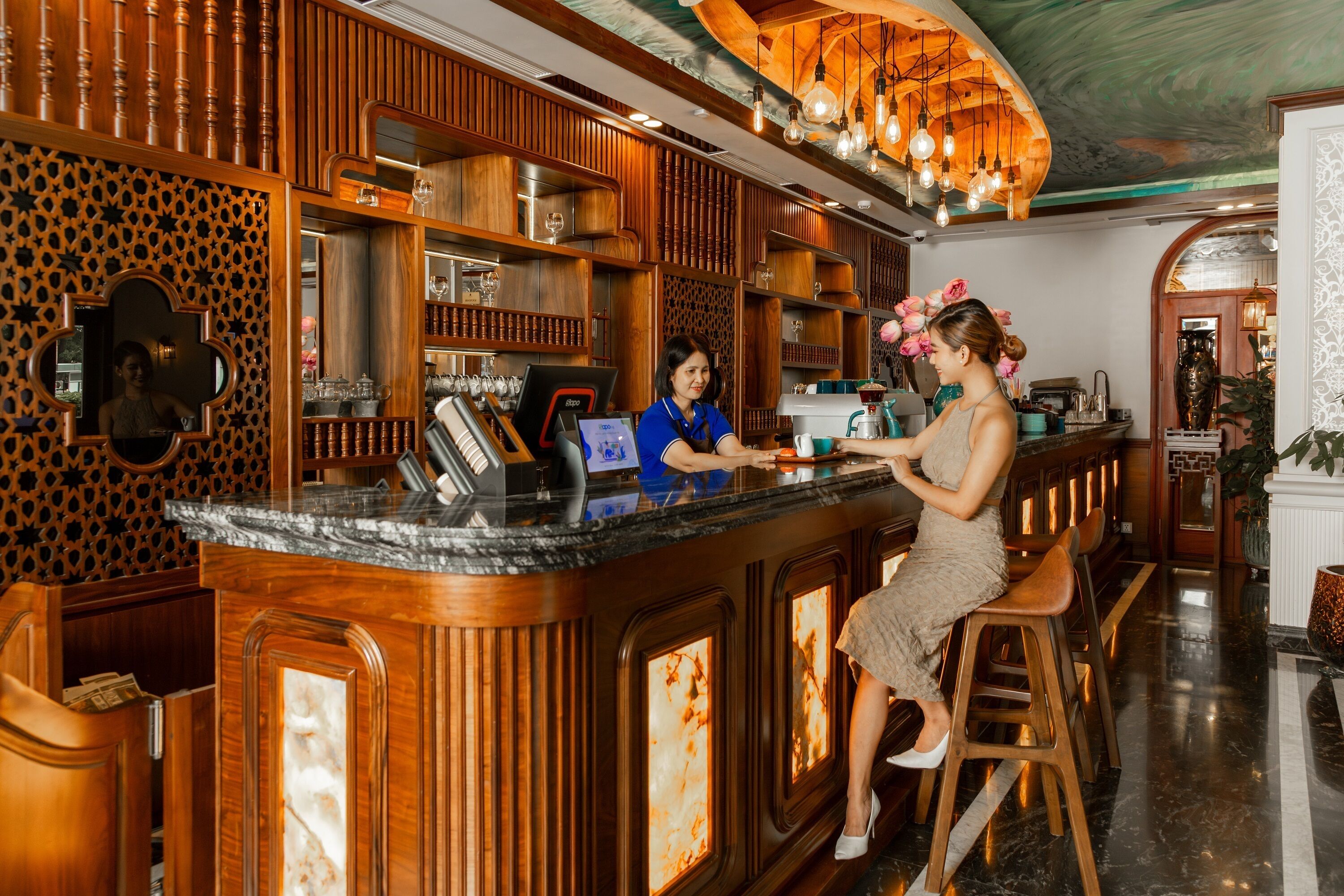 A bar area with wooden decor, a counter, and bar stools.