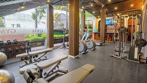 A gym with various exercise equipment, including treadmills, weight machines, and free weights. - Grand Fleuve Boutique  (Bai Chay)