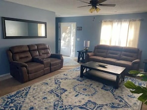 Relax in this stylish living room with two comfortable sofas, a coffee table, and a cozy rug.
