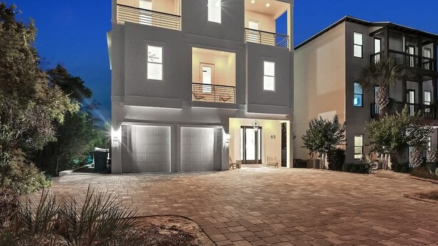 A multi-story residential building with a central entrance, balconies, and a driveway. - Barton Vista Del Mar | Paradise Perfected!! | Deeded Access with Free Beach Chairs & Umbrellas 100 Yards Away! (Miramar Beach)