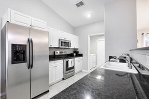 Enjoy cooking in this well-equipped kitchen with a gas stove, microwave, and refrigerator.