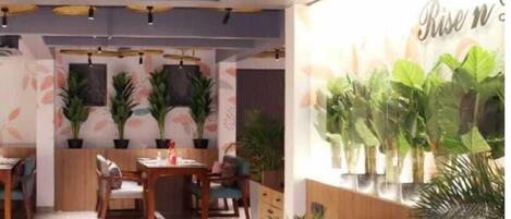 A restaurant with a wooden ceiling, a red sofa, and a wall with a 'Rise' sign.