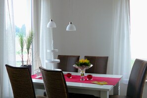 Enjoy meals in style with a beautifully set table for two, complete with a vase and candle holders.