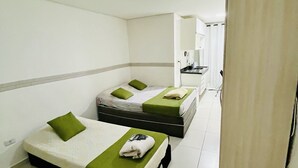 A hotel room with two beds, a kitchenette, and a bathroom. - Hotel 34 (Guarulhos)