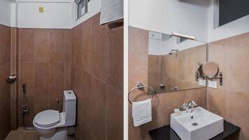 Um banheiro moderno com vaso sanitário, pia e chuveiro.