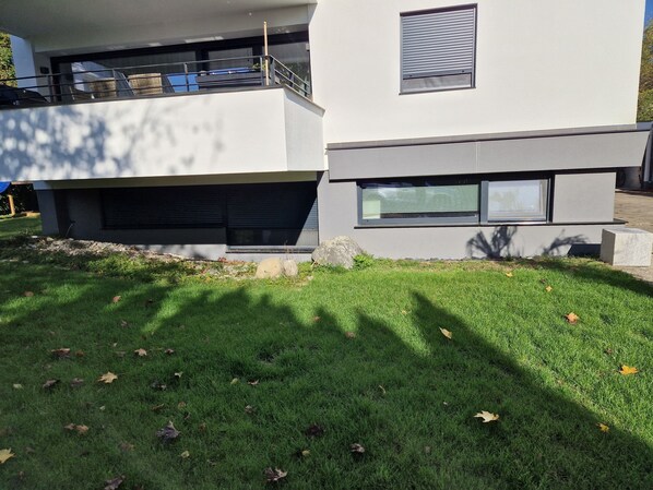 A modern two-story building with a flat roof and large windows.