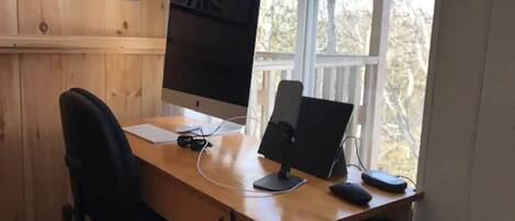 Escritorio de madera con una computadora, incluyendo monitor, teclado y ratón.