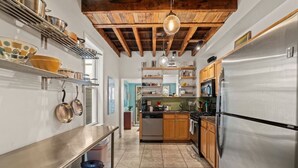 A kitchen with wooden beams, stainless steel appliances, and a central island. - Fairmount Neighborhood Gem! (Philadelphia)