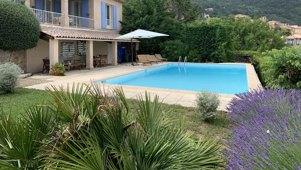 A two-story house with a swimming pool, outdoor seating, and a view of the surrounding hills. - Beautiful Villa, big pool,  overlooking valley, walking distance to town.  (Seillans)