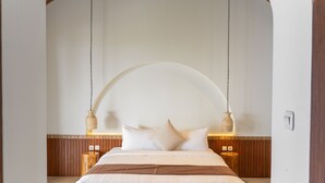 A bedroom with a bed, wooden headboard, bedside tables, and hanging lamps. - Sunshine City View Villa 6BR wth a private Heated Pool (Cimenyan)