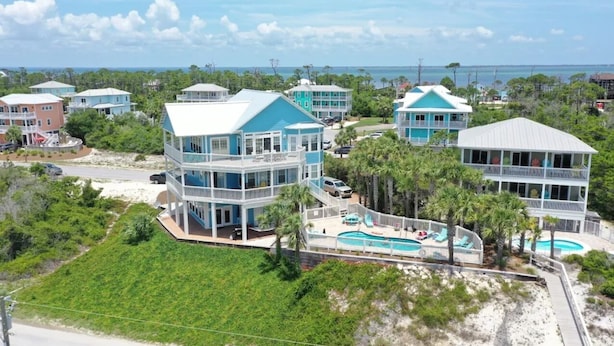 A coastal property with multiple buildings, a swimming pool, and a beach view. - Sea Grass Neighborhood * Private Pool 5 Bdrms (Cape San Blas)