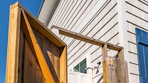 A wooden gate leading to a house with white siding and a blue door. - (4 Minute Walk to Beach) Screened in porch & MBR  on ground level (Cape San Blas)