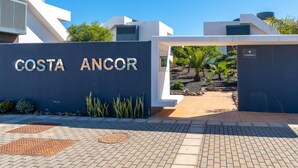 A modern entrance with a sign reading "COSTA ANCOR". - Cozy apartment with pool (CN)