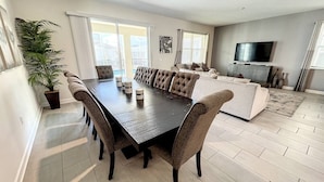 A modern living room with a dining table, sofas, and a TV. - Cinema Paradise: Last Minute Deal Private Pool/Spa (Davenport)