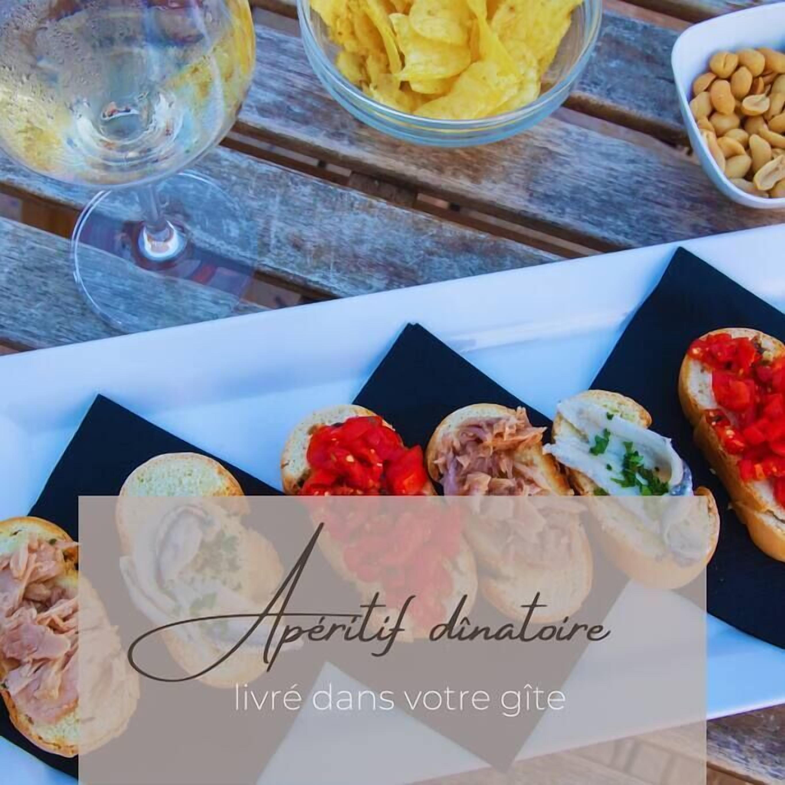 A table with various food items and a glass of wine.