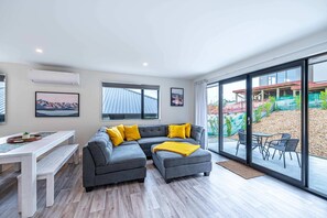 Relax in this inviting living space with a comfortable sofa, a bench, and a small table.