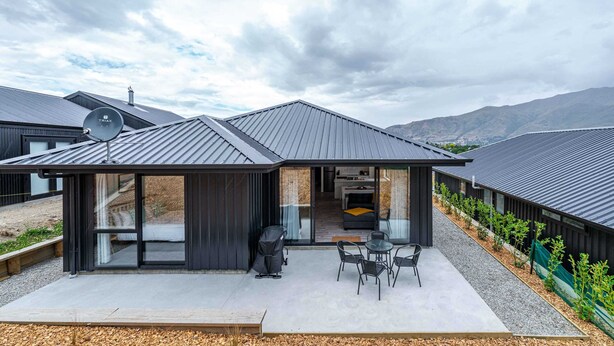 A modern house with a covered patio, a satellite dish, and a view of the mountains. - Kirimoko Family Retreat (Wanaka)
