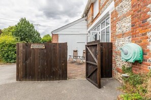 Welcome to Primrose Cottage, where a charming entrance invites you to relax in a peaceful seating area.