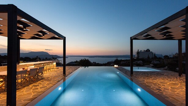 An infinity pool with a view of the sea and mountains at dusk. - TIMORI, modern, panorama views, pool & kiddie-pool, 4 bedrooms plus guest house. (PLAKA)