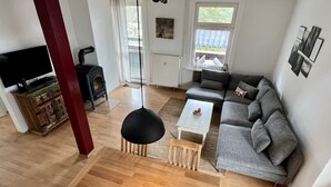 A modern living room with a sofa, a coffee table, and a TV.