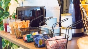 A countertop with various food items and condiments, including baskets of bread and jars of sauces. - Quiet, comfortable TORIS B&B (Neuil)