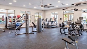 A gym with treadmills, weight machines, and exercise balls. - Beautiful Lake View House with 3/2 near Disney, Universal, Sea World and more! (Sparta)