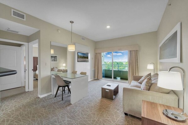 A modern hotel room with a balcony, a dining area, and a living space. - Suite · The Point Lux Suite, close to Universal (Orlando)