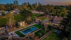 A residential area with a swimming pool, a small gazebo, and a large house with a well-maintained lawn. - Eastside Eden - Pool, Hot Tub and Tastings Included (Healdsburg)