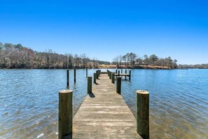 A wooden pier extending into a calm lake, surrounded by trees and clear skies. - Pizza Friday (Ridge)
