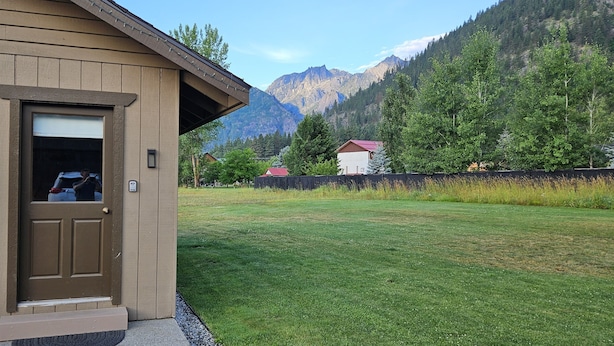 A guest house with a wooden exterior, a door, and a sign indicating it is a guest house.
