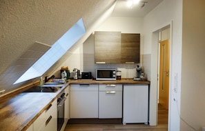 Fridge, stovetop, dishwasher, coffee/tea maker