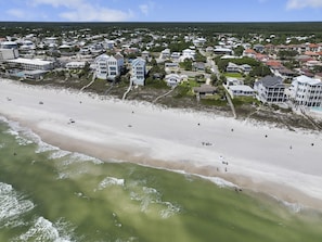 An aerial view of a coastal residential area with beachfront properties, a sandy beach, and ocean waves. - 5 Bed, 5 Bath Beach Home/only a 3 Minute Walk To The Beach! Sleeps 12 (Panama City Beach)