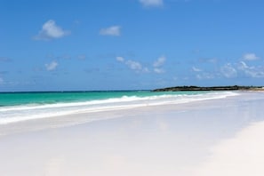 A beach with clear turquoise water and white sand. - Utopia House 3 Bedroom Home (Savannah Sound)