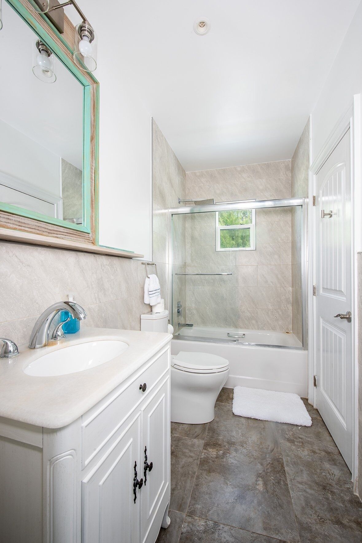 Une salle de bain avec un lavabo blanc, des toilettes, une baignoire et une douche.