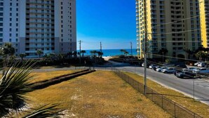 Un grand hôtel à plusieurs étages, doté d’un parking et offrant une vue sur la plage.