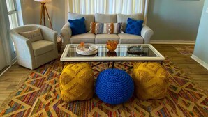 Un salon avec un canapé, un fauteuil et une table basse.