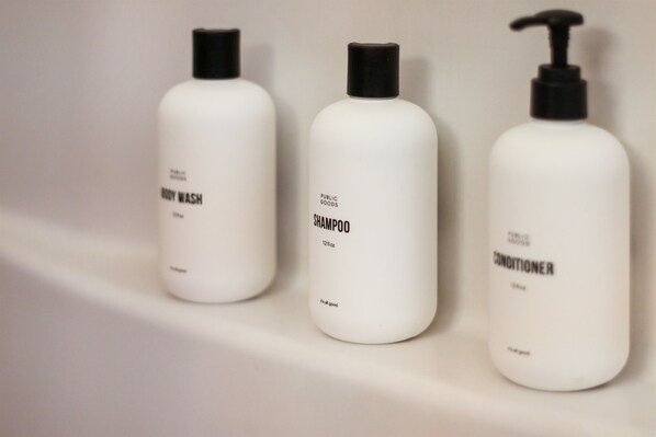 Three white bottles with black pumps, labeled 'BODY WASH,' 'SHAMPOO,' and 'CONDITIONER.' - Mountain View Cozy Cabin - Penny's Peak (Nebo)