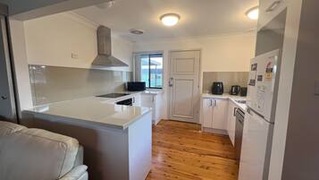 Fridge, stovetop, dishwasher, dining tables