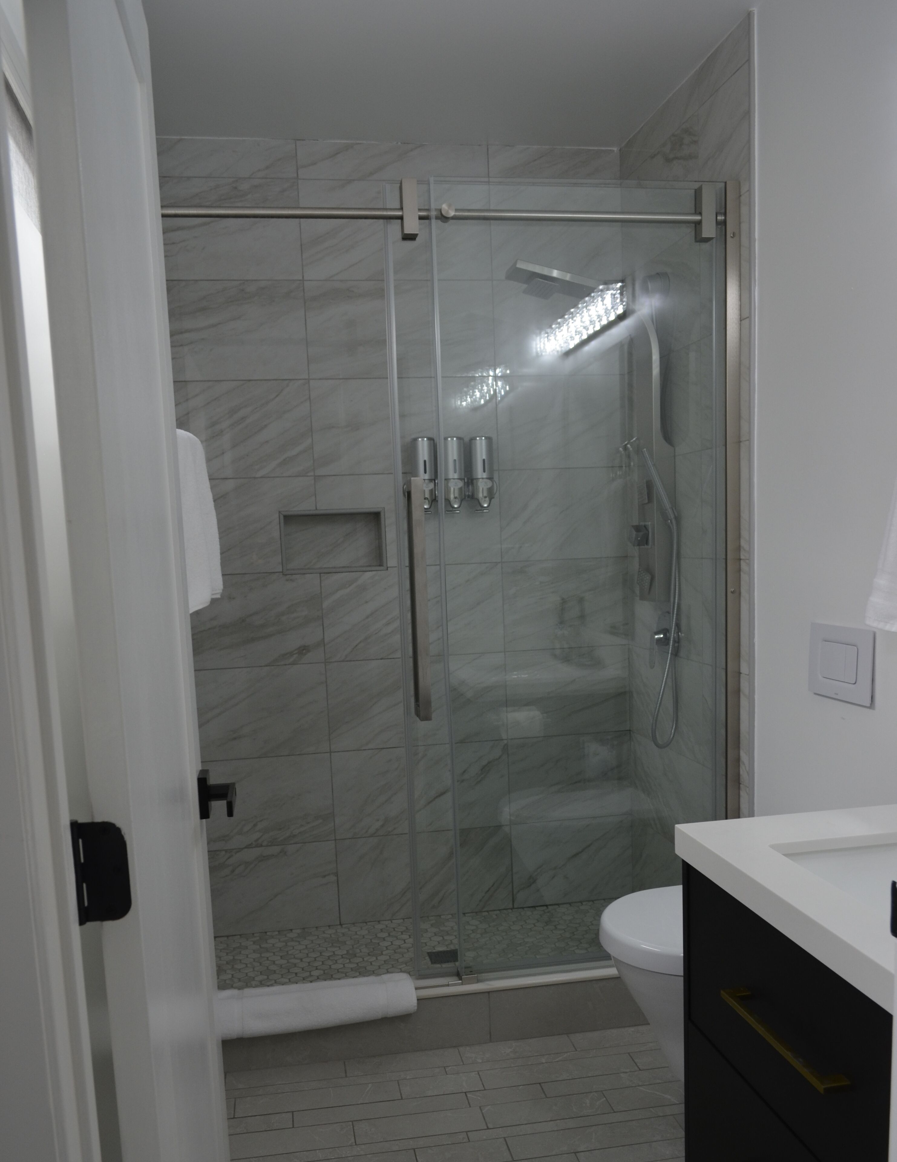 Shower, hydromassage showerhead, eco-friendly toiletries, hair dryer