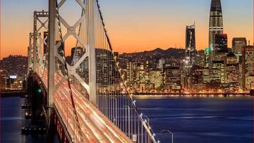 A city skyline with a prominent bridge in the foreground.