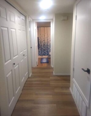 Enter a cozy space with a patterned curtain and a comfortable bench.
